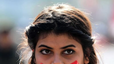 An Iraqi university student with mouth taped attends a protest in central Baghdad, Iraq. EPA