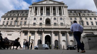 People walk past the Bank of England in central London on Thursday. AP Photo / Frank Augstein