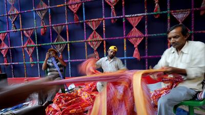Artists work on a makeshift pandal made with wood, cotton, metal and bamboo under a theme 'We All Are Durga' by Bhabotosh Sutar and Mallika Das Sutar ahead of the Durga Puja festival in Kolkata, India. EPA