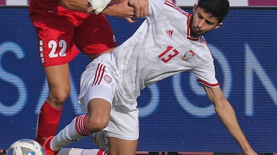 Lebanon's Bassel Jradi and Ahmed Barman of the UAE battle for ball. AFP