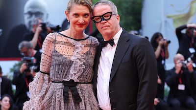 Food writer Alessandra Mion, in a lace overlay dress, and Ernst Knam, in a tuxedo and eye mask. Getty Images