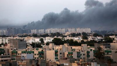 Smoke fills the sky over Tripoli after fighting between militias of Libya Fajr (Dawn of Libya) and Karama (Dignity). Photo: EPA / STR