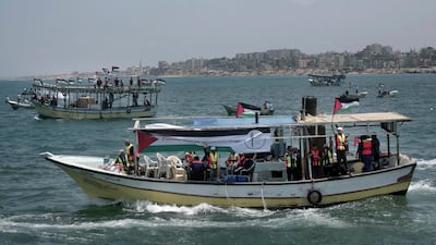 Two Palestinian fishing boats sail carrying 20 people including medical patients and students unable to leave through overland crossings, in Gaza City, Tuesday, May 29, 2018. Palestinian activists have set sail in defiance of years of an Israeli and Egyptian naval blockade on the Gaza Strip. Khalil Hamra / AP