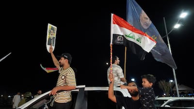 Supporters of a Shiite armed group celebrate the withdrawal of coalition forces from Iraq, ending a military presence that began after the 2003 US-led invasion, in Basra. Reuters
