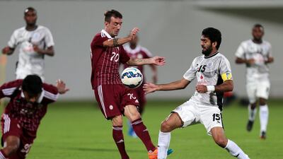 Al Wahda's Damian Diaz, centre, battles for the ball against Al Sadd's Talal Al Bloushi. Christopher Pike / The National