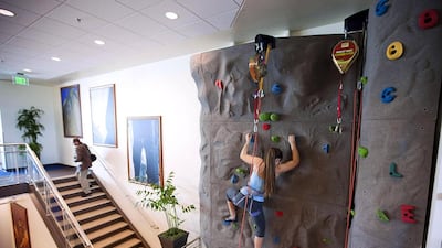 An employee uses the climbing wall during the grand opening of Google Kirkland in 2009. Stephen Brashear / Getty Images / AFP