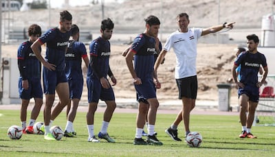 Iraq's Slovenian coach Srecko Katanec, second right, directs his players during a training session at a training camp in Doha. Qatar. AFP