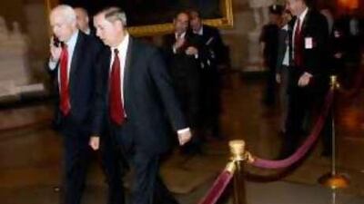John McCain, left, in Washington, DC, where he has striven to ease the financial crisis.