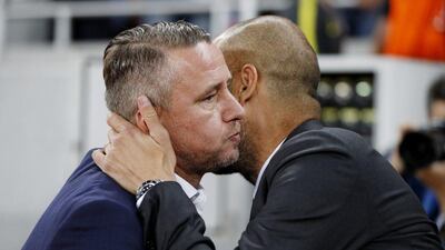 Manchester City manager Pep Guardiola and Steaua Bucharest coach Laurentiu Reghecampf before the game. (Reuters)