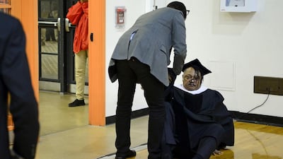 A young girl, left, reacts as a man helps up the Rev Jesse Jackson after he tripped over a cable and fell to the floor while arriving to address graduates at the winter commencement exercises at Morgan State University in Baltimore. Jackson was uninjured from the fall and went on to address the graduates as planned. Bryan Woolston / Reuters