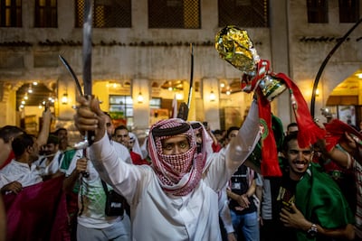 Morocco fans celebrate the team's World Cup win against Spain at the Souq Waqif market in Doha. EPA