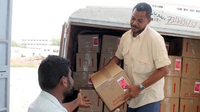 Yemenis unload boxes of aid, supplied by a Kuwaiti medical organisation, at Al Sadaqa hospital in Aden on April 4, 2015, amid fierce fighting for control of the southern port city. Saleh Al Obeidi / AFP