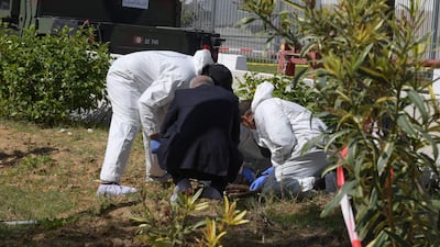 Forensic experts investigate at the scene of an explosion near the US embassy in Tunis. AFP