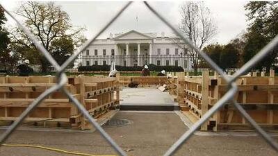 With the White House in the background, workers continue to build the presidential inauguration reviewing stand in Washington.