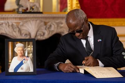 Morie Komba, High Commissioner of Sierra Leone, signs a book of condolence at Lancaster House in London following the death of Queen Elizabeth. AFP