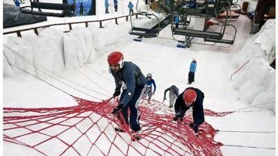 Competitors face obstacles in the Ice Warrior Challenge III to raise money for the Beit Al Khair society at Ski Dubai. Charles Crowell for The National
