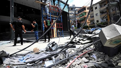 A shopkeeper has his store repaired after Israeli military strikes on the southern Lebanese coastal city of Tyre. Job losses in the country have been distributed unevenly across economic sectors. AFP