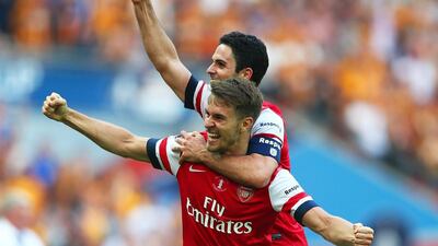 Aaron Ramsey, left, and Mikel Arteta of Arsenal celebrate victory after the FA Cup final against Hull City on Saturday. Clive Mason / Getty Images / May 17, 2014