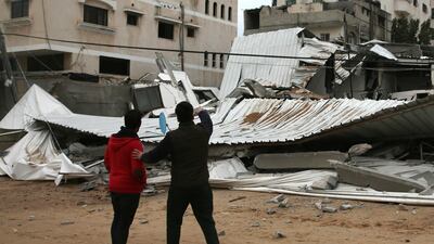 Palestinians inspect the damage of destroyed building belongs to Hamas ministry of prisoners hit by Israeli airstrikes. AP Photo
