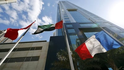 The French national flag flies at half-mast beside the flag of the UAE, in front of the Habtoor Business Tower location of the French Consulate in Dubai. EPA