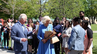 Britain's Prince Charles and Camilla, Duchess of Cornwall greet students during a visit at Assumption Catholic school in Ottawa. AFP