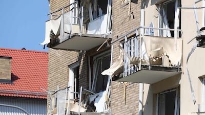 Damaged balconies and windows are seen at a block of flats that were hit by an explosion Friday morning. AFP