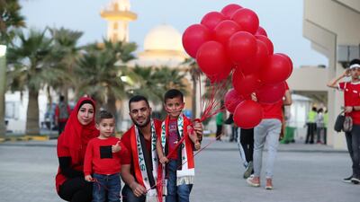 Syrian fans Shadi Rihan, his wife Samah and their children Zaid (left) and Ryan (right) have their team colours ready before the start of AFC Asian Cup UAE 2019 football match between Syria and Palestine at Sharjah Football Stadium in Sharjah. Pawan Singh / The National