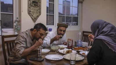 Imam Raza Ahmed, his brother Rizwan and wife Anam take iftar, the fast-breaking meal after sunset at their family home in London, England. Getty Images