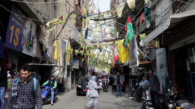 Posters showing Palestinian leaders and Fatah flags hang in a street in the Burj Al Barajneh camp. ANWAR AMRO / AFP