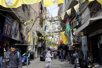 Posters of Palestinian leaders and Fatah flags hang in a street in the Burj Al Barajneh camp. ANWAR AMRO / AFP