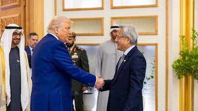 Mr Trump greets Jensen Huang, president and chief executive of Nvidia, at Qasr Al Watan as Sheikh Mohamed watches. Photo: UAE Presidential Court