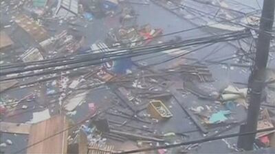 Debris float on a flooded road as strong winds and rain continue to batter buildings after Typhoon Haiyan hit Tacloban city, Leyte province. ABS-CBN via Reuters