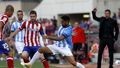 Gabi, centre, Diego Simeone, back right and the rest of Atletico Madrid will try to win a La Liga-Champions League double over the next two weeks. Alberto Di Lolli / AFP