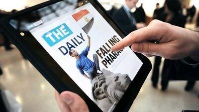 A journalist looks at the front page of The Daily, an electronic newspaper designed for the iPad, after its launch was announced at the Guggenheim Museum in New York. AFP PHOTO/Stan Honda