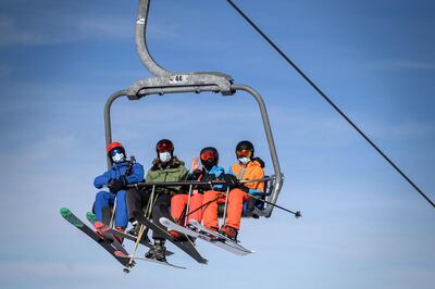 Skiers wearing face masks in the Swiss Alps. AFP