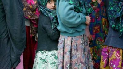 Afghan girls queue for their lunch at the Allahuddin orphanage in Kabul.
