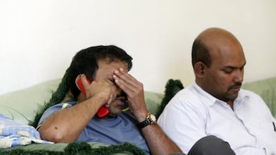 Nazeer Ahmed, left, father of Nizaha Aalaa, a young Indian girl that died, being consoled by family and friends in his home in Abu Dhabi. Christopher Pike / The National