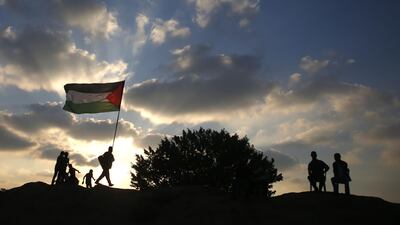 Palestinian protesters gather on a slope during clashes with Israeli forces in the central Gaza Strip. AFP