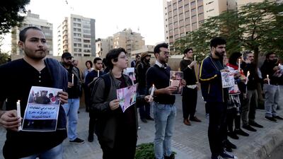 Lebanese demonstrators carry pictures of Iraqis killed during protests as they stage a candlelight vigil outside Iraq's embassy to denounce the excessive use of force against demonstrators there, in the capital Beirut. AFP