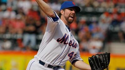 New York Mets' RA Dickey delivers a pitch in the first inning against the St. Louis Cardinals