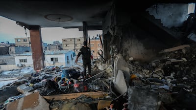 Palestinian citizens inspect the destruction caused by air strikes on their homes in Khan Yunis, Gaza. Getty
