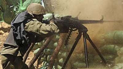 A government soldier fires at Tamil Tiger insurgents in Kilinochchi, about 330km north of the capital Colombo, on Sept 22 2008.