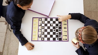 Zain Samer Khalid, 7, left, and Freya Jones, 7, at right, enjoy a game of chess at the Brighton College in Abu Dhabi, the first foreign campus of the well-known British school. Over 4,000 players from 120 countries will descend on Al Ain for the World YouChess Championship from Wednesday to December 29. Silvia Razgova / The National