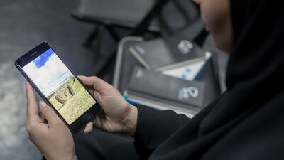 A student looks at images on her phone during a session of the Social Media Influencers Diploma. Ruel Pableo for The National