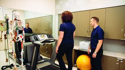 Physiotherapist Galen Carroll looks on as his colleague Andrea Duggan demonstrates a healthy gait. Anna Nielsen for The National