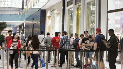 Apple fanatics wait in line, hoping to be among the first few to get their hands on the new iPhone XS at the Apple store in Dubai Mall. Leslie Pableo / The National