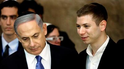 This photo taken on March 18, 2015 shows Israeli premier Benjamin Netanyahu (L) and his son, Yair, visiting the Wailing Wall in Jerusalem. Thomas Coex / AFP