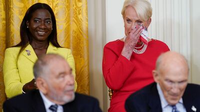 Cindy McCain wipes her eye as Mr Biden praises her late husband senator John McCain during the White House ceremony. AP