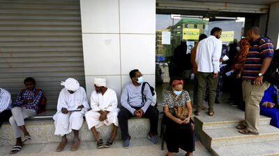 People outside an exchange bureau in Khartoum. The International Monetary Fund has approved a $2.5 billion extended credit line for Sudan. Reuters