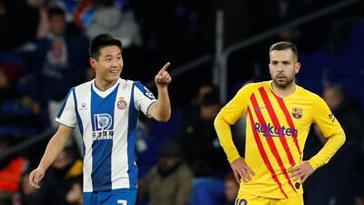 Espanyol's Wu Lei celebrates scoring their second goal as Barcelona's Jordi Alba looks dejected. Reuters